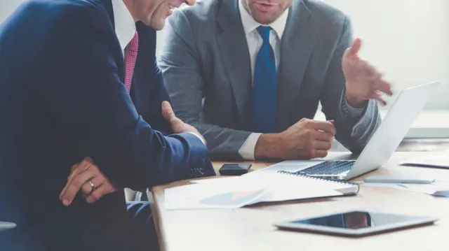 Men talking in an office