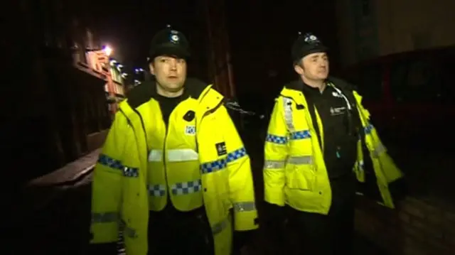 Police officers on patrol at night