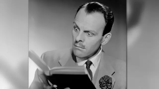 Terry Thomas reading a book