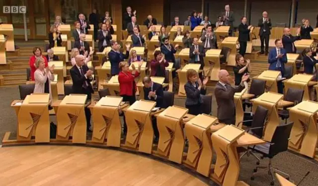 Members applaud the women in the public gallery