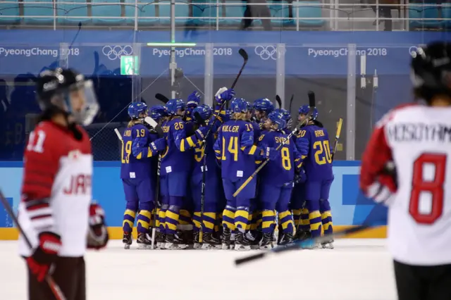 Sweden's women's Ice Hockey team celebrate their win over Japan.