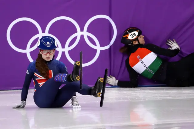 Great Britain's Kathryn Thomson crashes in the first corner.