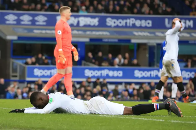 Christian Benteke lying on the turf