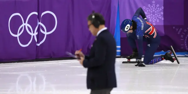 Charlotte Gilmartin of Great Britain penalized for her part in the crash in the short track speed skating.