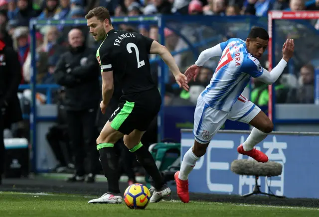 Rajiv van La Parra of Huddersfield Town runs with the ball past Simon Francis