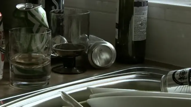 Empty glasses and bottles next to sink