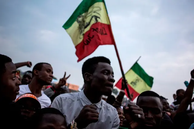 Congolese festival-goers dance during a performance at the Amani Festival on February 10, 2018 in Goma. The Amami Festival runs from Febraury 9 to 11, promoting peace and culture in eastern Democratic Republic of Congo and Great Lakes region.