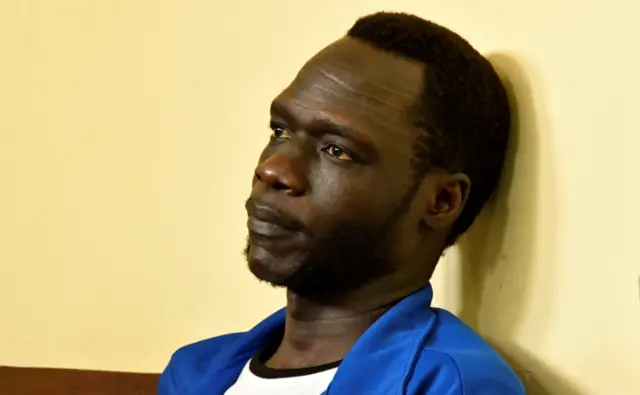 James Gatdet Dak, a former spokesman of rebel leader Riek Machar, sits inside the dock in the High Court in Juba, South Sudan February 12, 2018