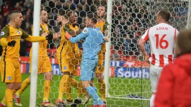 Charlie Adam looks on in dismay as Brighton goalkeeper Mat Ryan is congratulated by his team-mates for saving the Stoke midfielder's late spot-kick