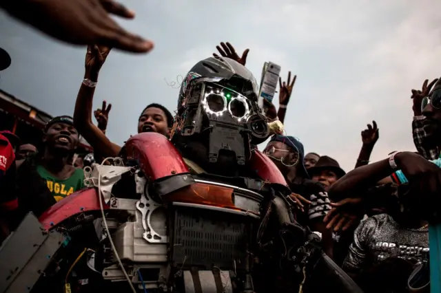 A Congolese festival-goer dressed as a robot attends the Amani Festival on February 10, 2018 in Goma. The Amami Festival runs from Febraury 9 to 11, promoting peace and culture in eastern Democratic Republic of Congo and Great Lakes region.