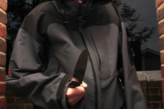 Hooded youth with knife