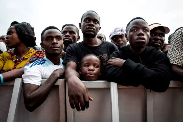 Congolese festival-goers look on during a performance at the Amani Festival on February 10, 2018 in Goma. The Amami Festival runs from Febraury 9 to 11, promoting peace and culture in eastern Democratic Republic of Congo and Great Lakes region.