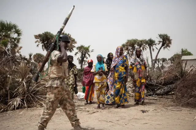 A Nigerian soldier, with a rocket propelled grenade (RPG), patrols on the outskirt of the town of Damasak in North East Nigeria on April, 25 2017