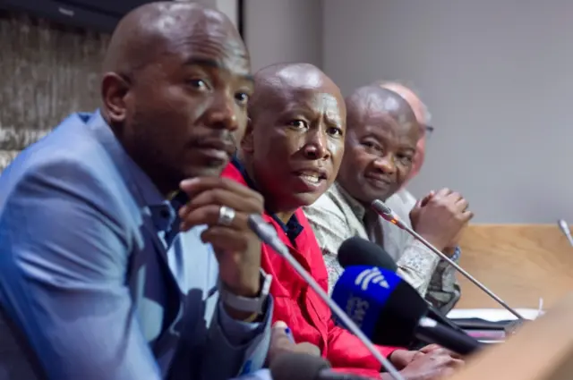 Economic Freedom Fighters (EFF) party leader Julius Malema (2nd L) speaks flanked by Democratic Alliance (DA) party leader Mmusi Maimane (L), United Democratic Movement leader Bantu Holomisa (2nd R) and Corne Mulder (R) of the Freedom Front Plus (FF+)