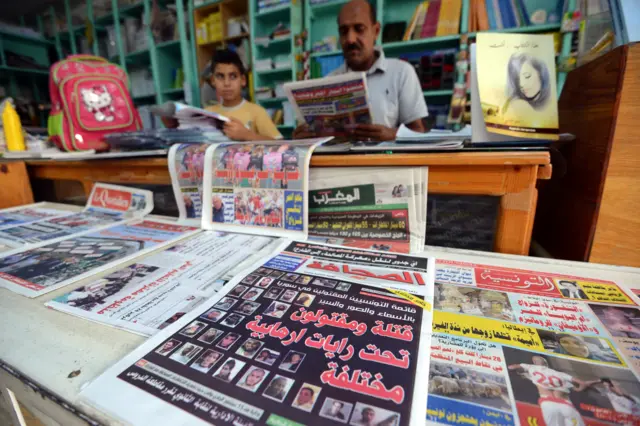 A picture taken on September 6, 2015 shows a copy of a pro-government Tunisian daily newspaper 'Essahafa' (C) at a kiosk in the Tunisian capital, Tunis.