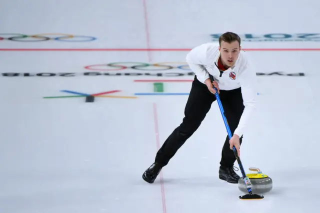 Norway's Magnus Nedregotten brushes the ice surface