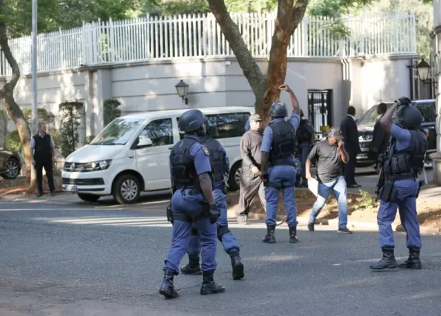 Members of the Hawks special police unit raid the compound of the Gupta family during an early morning raid, Johannesburg, South Africa, 14 February 2018