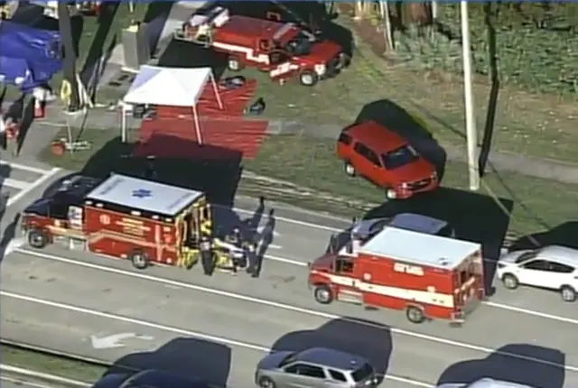 A victim is loaded into an ambulance