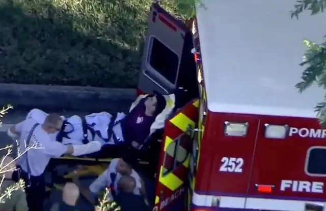 A man placed in handcuffs was seen being loaded into a paramedic vehicle after a shooting in Parkland, Florida.