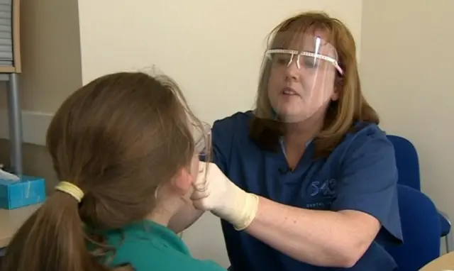 Child having teeth checked