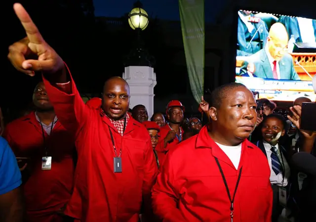 Economic Freedom Fighters (EFF) leaders Floyd Shivambu (L) and Julius Malema (R) leaves parliament after being ordered to do so during President Jacob Zuma's annual State of the Nation Address in Cape Town, February 11, 2016.