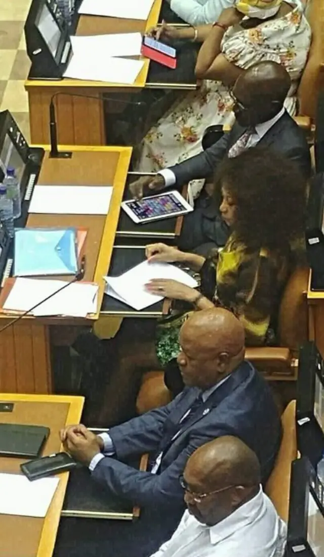 South Africa's Finance Ministe Malusi Gigaba playing Candy Crush whilst his new boss, Cyril Ramaphosa, is speaking.