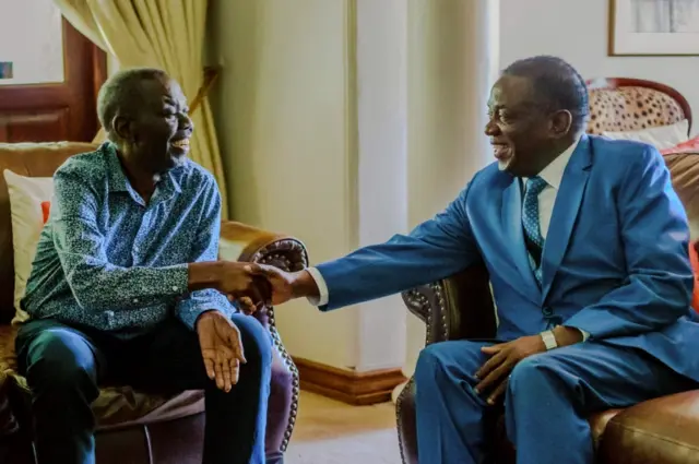 Zimbabwe's President Emmerson Mnangagwa (R) shakes hands with the leader of the Movement for Democratic Change (MDC), the country"s main opposition party, Morgan Tsvangirai (L), who has been battling cancer, during a visit at his home in Harare on January 5, 2018.