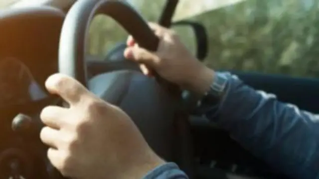 Hands on steering wheel