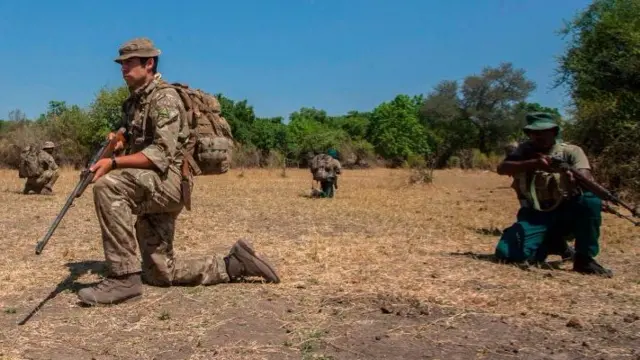 British trooper and Counter Poaching Operator Samuel Knuckey (C) leads participants in demonstration of field tactics for countering poachers during Counter Poaching Training course for Game Rangers at the Liwonde National Park in Machinga District South Eastern Malawi, on October 14, 2017