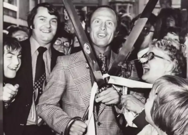 Geoffrey Boycott with giant scissors