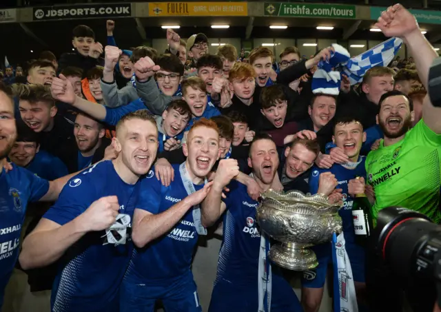 Dungannon Swifts players celebrate with their supporters after the club's 3-1 win over Ballymena United in the League Cup final.