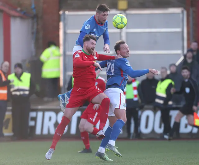 A fine leap from Linfield defender Mark Stafford as he clears the ball at Solitude