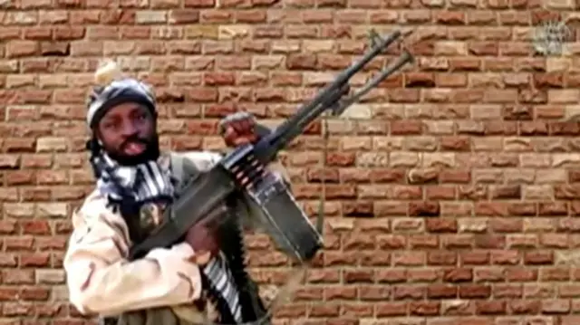 Leader of one of the Boko Haram group"s factions, Abubakar Shekau holds a weapon in an unknown location in Nigeria in this still image taken from an undated video obtained on January 15, 2018.