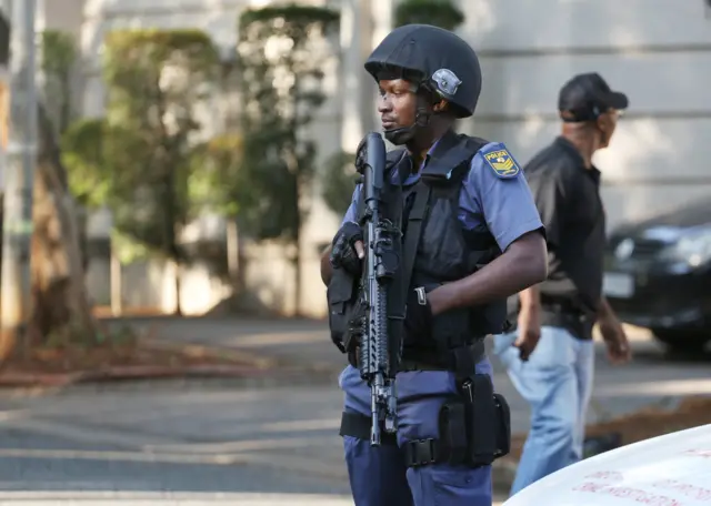 Members of the Hawks special police unit raid the compound of the Gupta family during an early morning raid, Johannesburg, South Africa, 14 February 2018.