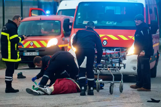 A migrant receives medical assistance by rescue workers following clashes near the ferry port in Calais, northern France, 01 February 2018.