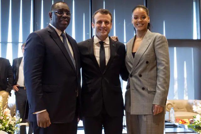 (L-R) Senegalese President Macky Sall, Barbadian singer Rihanna and French President Emmanuel Macron pose a they attend the conference 'GPE Financing Conference, an Investment in the Future' organised by the Global Partnership for Education in Dakar on February 2, 2018