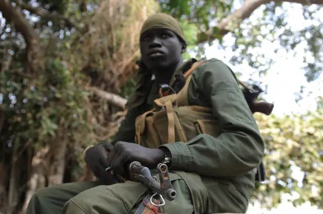 A member of South Sudan's army, Sudan Peoples Liberation Army (SPLA), sits outside the governor's compound in Malakal, the capital of the biggest oil producing state Upper Nile, on January 12, 2014