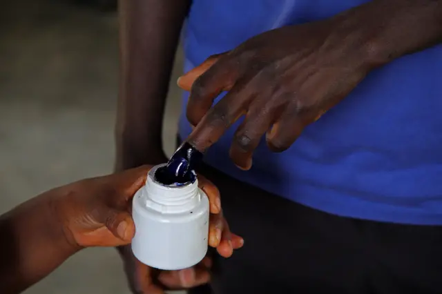A man has his fingers inked in order to vote at a polling station in Bujumbura on July 21, 2015, during Burundi's presidential election