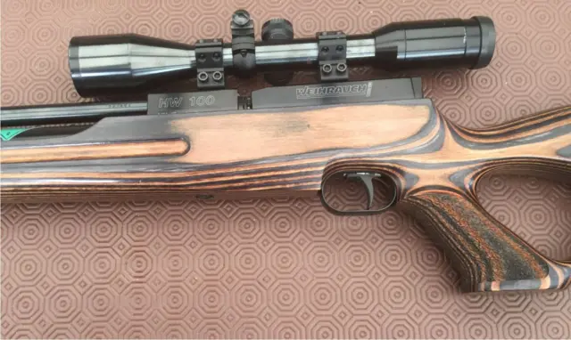 A wooden handle of the air rifle.