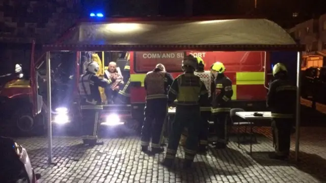 Fire crew vehicle and canopy on cobbled street