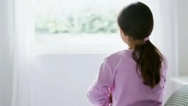 A child looking out of a window.