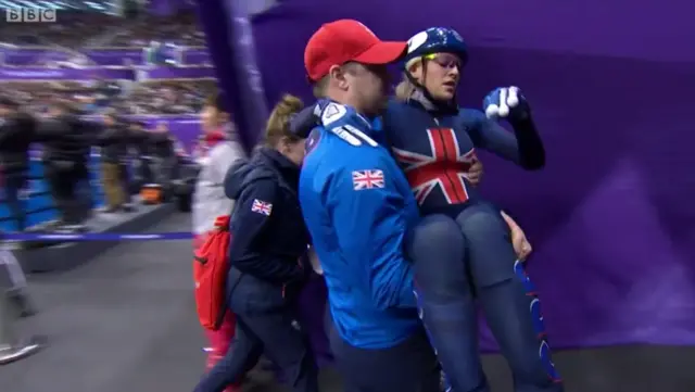 Elise Christie carried off the ice