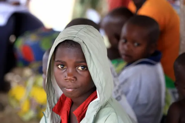 A Congolese boy, who migrated from Democratic Republic of Congo by fleeing on a boat across Lake Albert, rests after arriving in Ntoroko, Uganda February 17, 2018