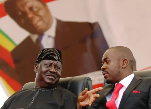 Nelson Chamisa, the new leader of Zimbabwe"s Movement For Democratic Change (MDC) talks to Kenyan opposition leader Raila Odinga at the funeral of Morgan Tsvangirai in Buhera, Zimbabwe February 20, 2018