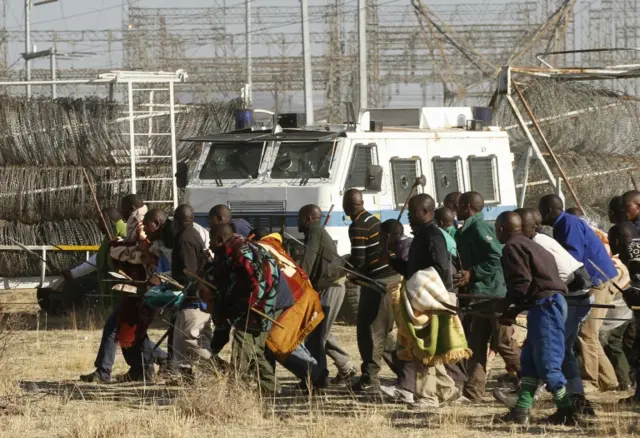 Protesting miners approach the police before they were shot at outside a South African mine in Rustenburg, 100 km (62 miles) northwest of Johannesburg, August 16, 2012