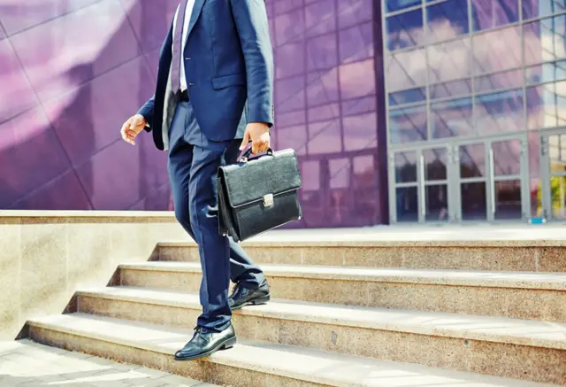 A man walking with a briefcase