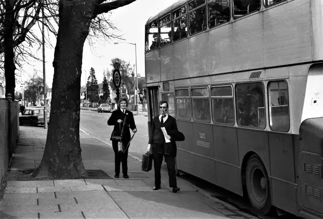 Bus workers with vehicle