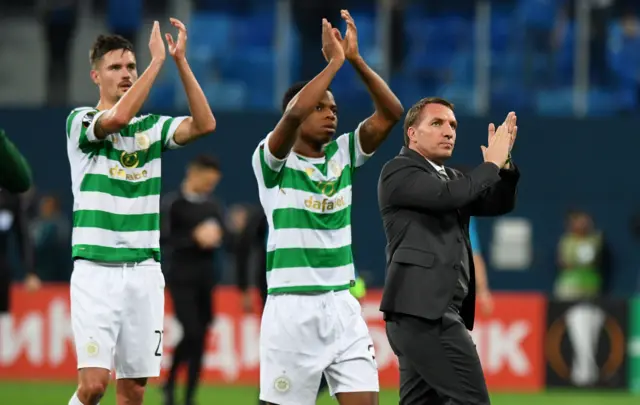 Celtic's Mikael Lustig, Charly Musonda and manager Brendan Rodgers applaud the fans