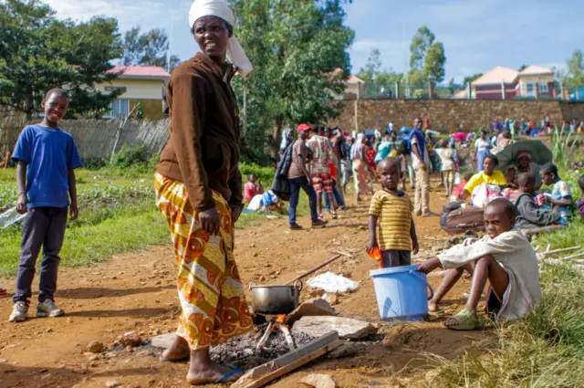 A refugee from the Democratic Republic of Congo is seen with her children as they prepare a meal near the United Nations High Commissioner for Refugees (UNHCR) offices in Kiziba refugee camp in Karongi District, Rwanda February 21, 2018