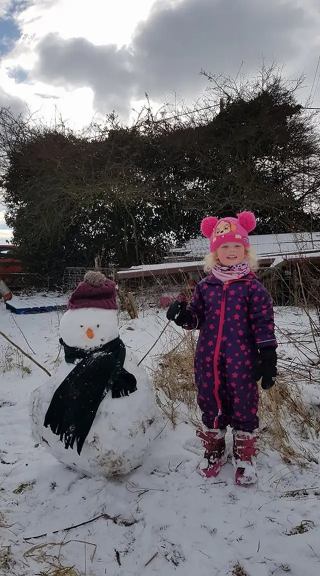 Poppy next to a snowman